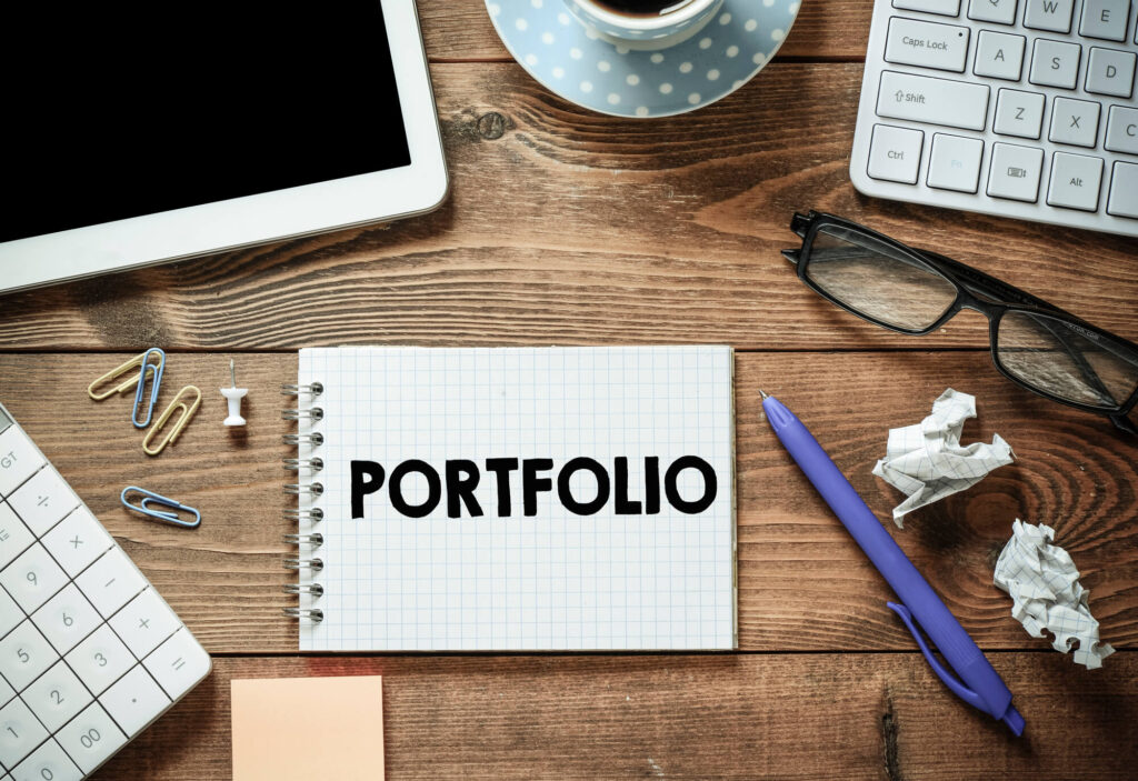 Creative portfolio workspace with notebook and office items — umama faiz.